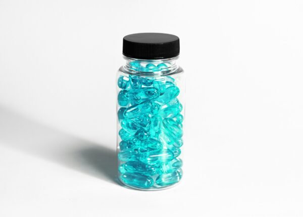 glass medication bottle with teal colored gel pills